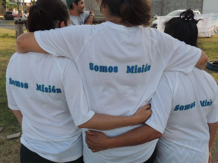 jovenes abrazados con camiseta misionera